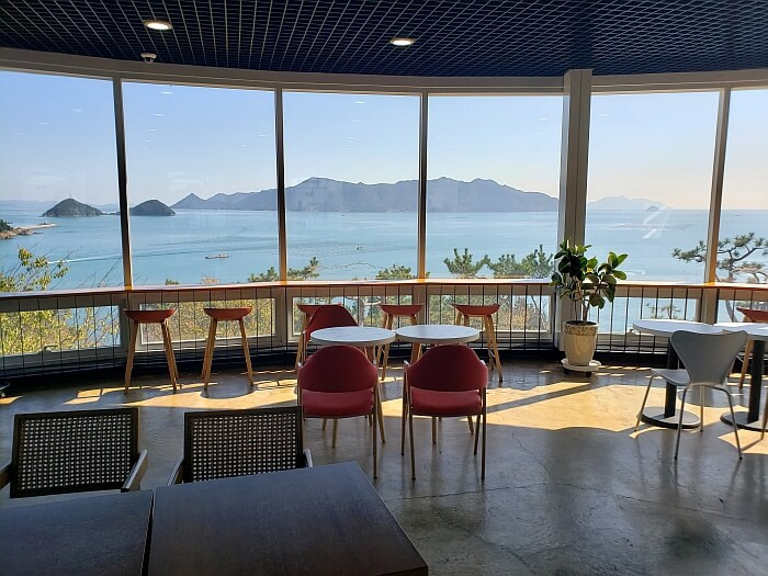 Café observatory with chairs along window with nice view of the sea and mountains