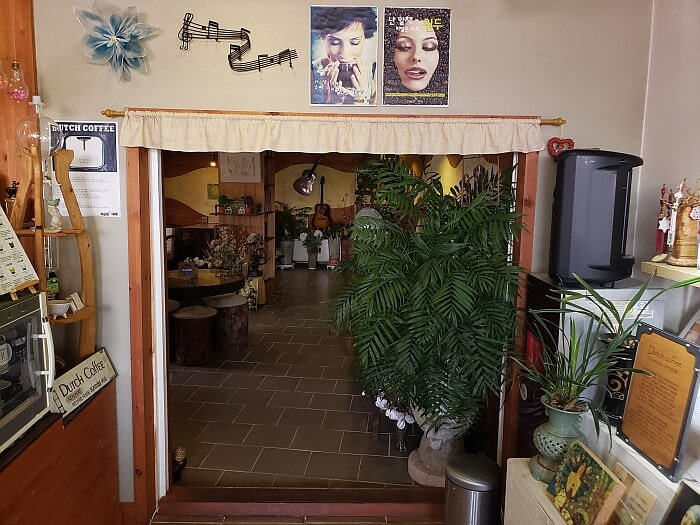 Dutch coffee signs and posters at a dining room entrance of a café