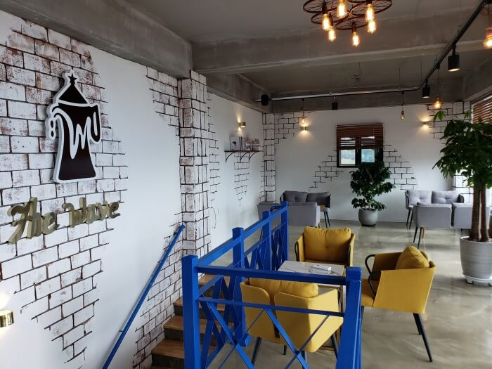 The Wave Café logo next to stairs on the second floor
