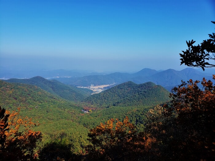 View of mountains surrounding a temple below
