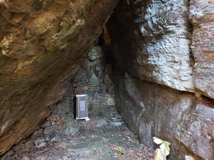 A metal box inside a cave with altars in South Korea