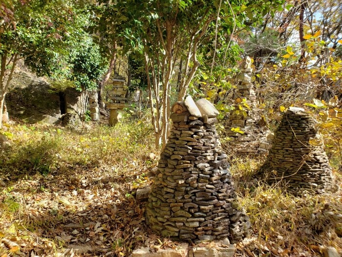 Stone pagodas in a clearing in a forest