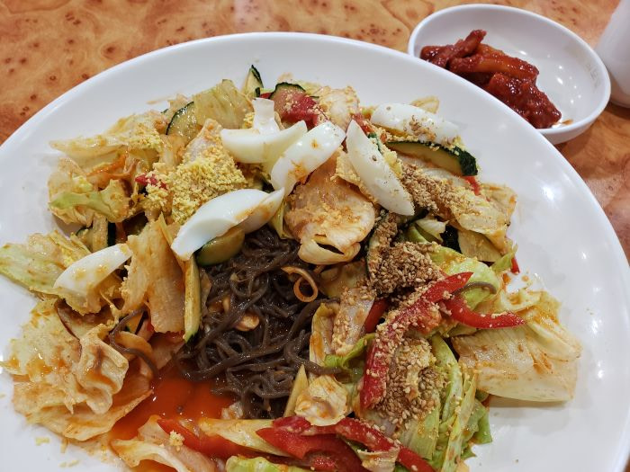 A plate of Korean makguksu noodles and veggies