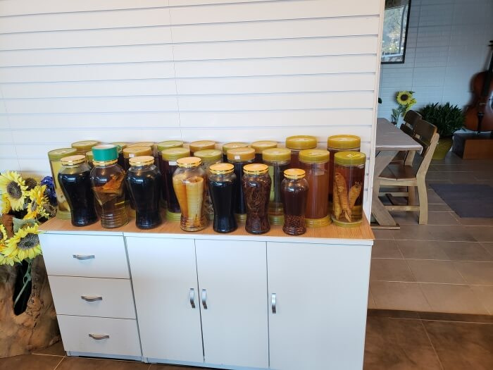 Roots jars of liquid on a shelf