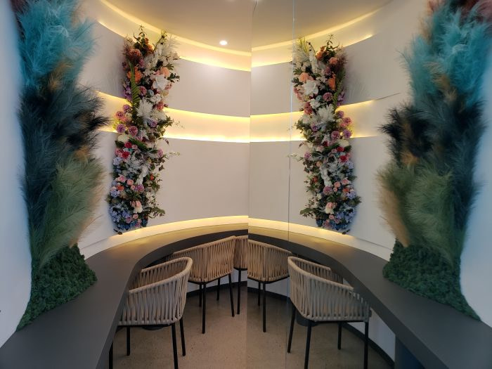 A wall mirror reflecting floral decorations