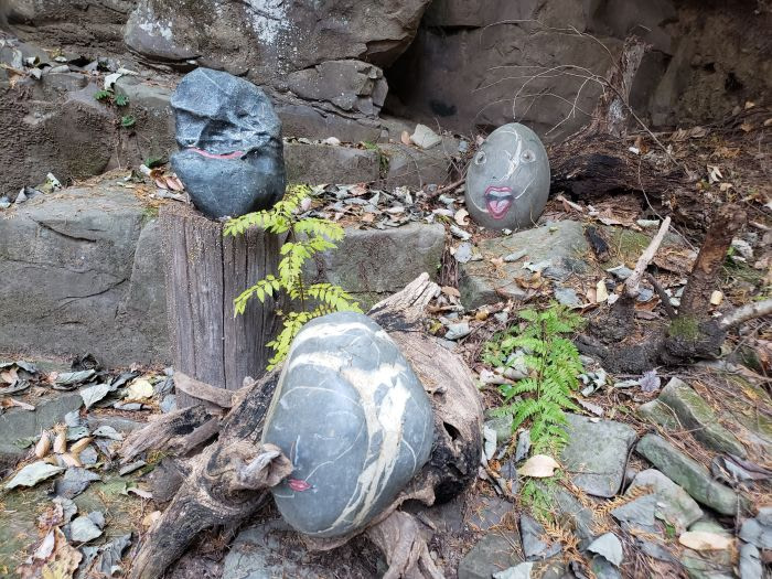 Painted faces on rocks at Odusan Healing Forest