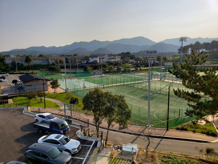 The rooftop view at Crepe Lion of the Goseong Sports Park and mountains beyond