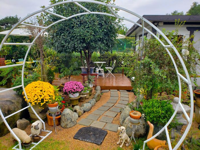 A table next to garden paths and flowers
