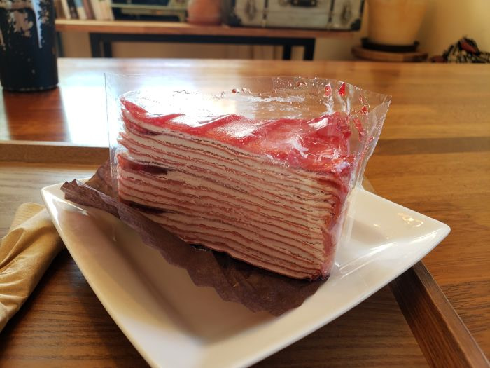 A slice of strawberry crepe cake