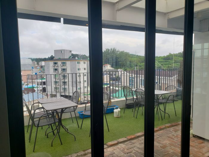 Balcony with tables and chairs overlooking the town center and mountainside