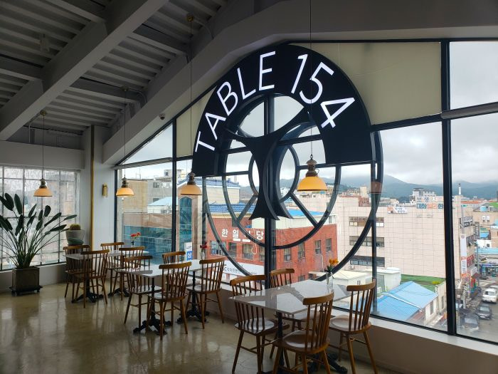 Large window in Table 154 restaurant and café overlooking the Goseong town center