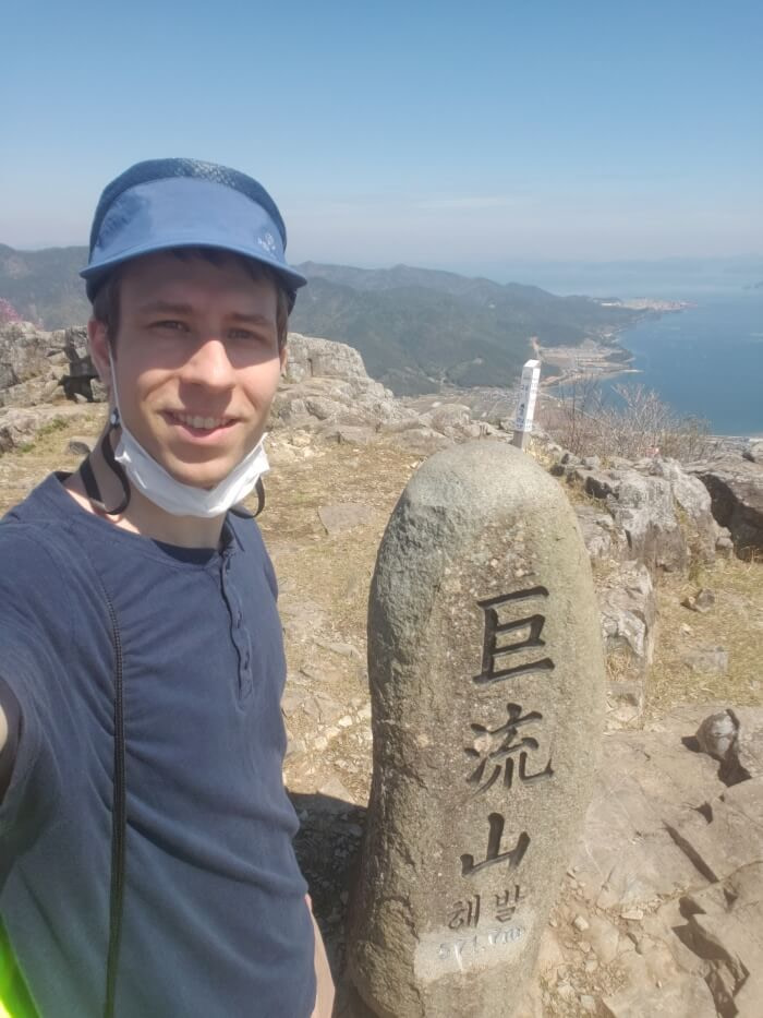 Nate standing with the Georyusan headstone