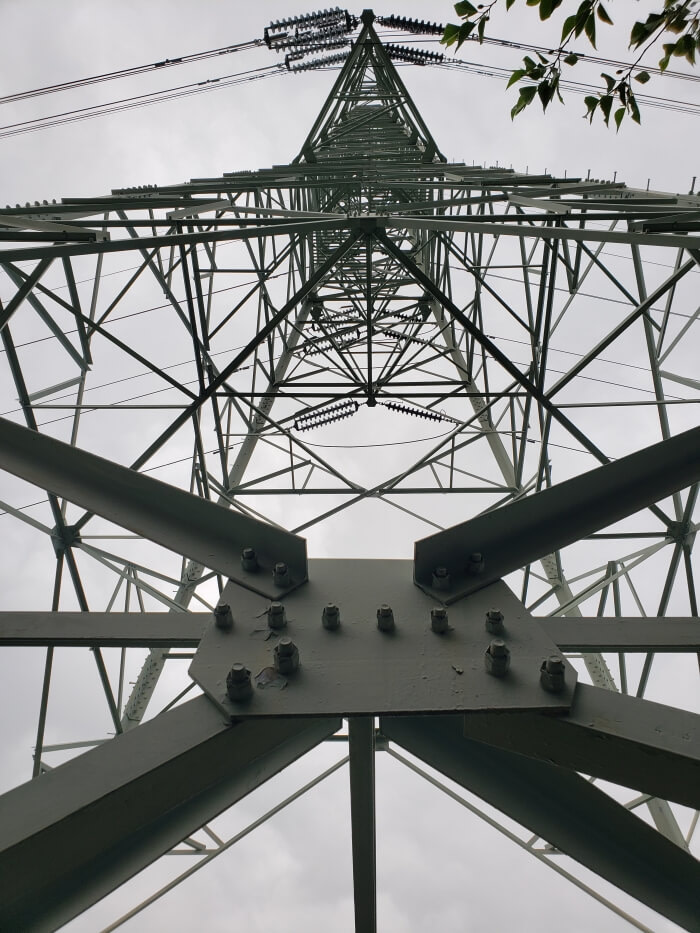Looking up at an electrical tower