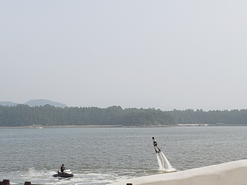 Dude on ski jet and water ski