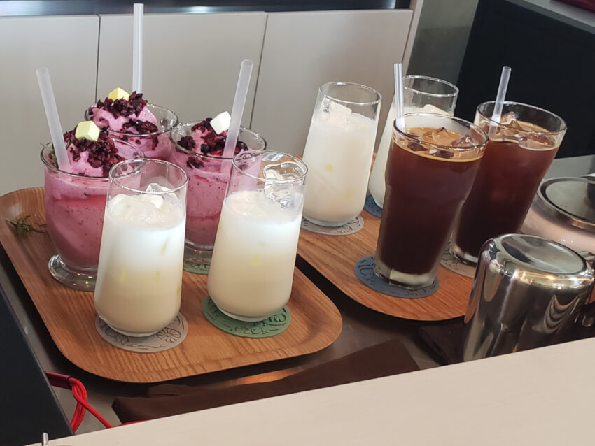 Two trays of drinks being served