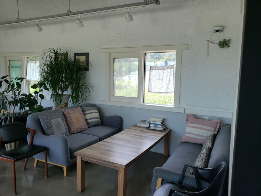 A set of couches around a table and window