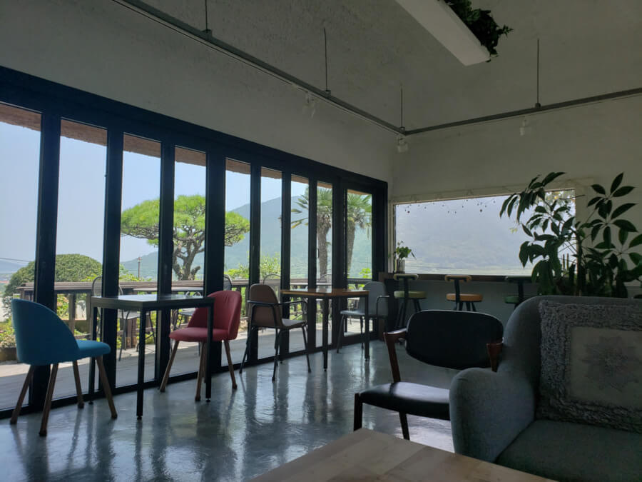 Smaller tables and some stools along the window
