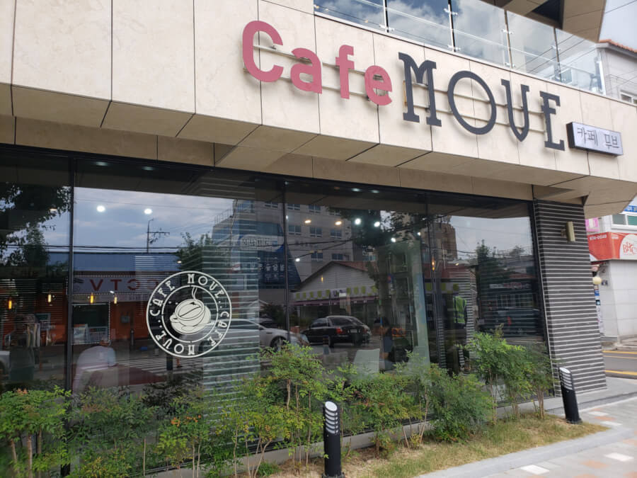 Outside the café looking at the large window and sign