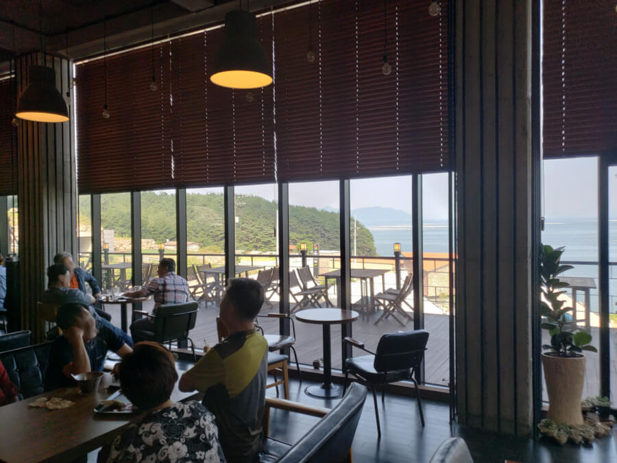 People enjoying Polaris cafe with a view of the sea
