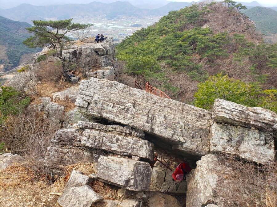 Person going through a rock cave