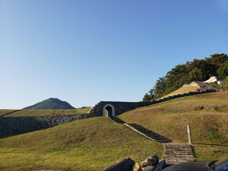 Stone steps leading into a fortress along grassy slopes