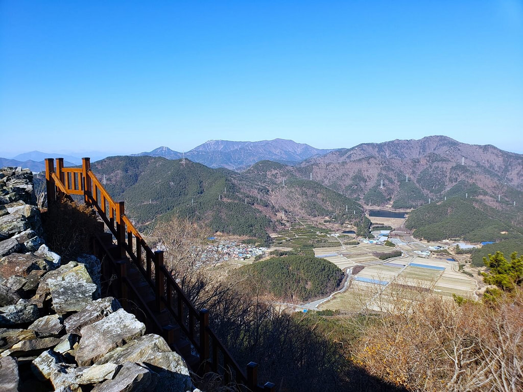 Wooden stairs along a rock wall on Jwaisan against mountains